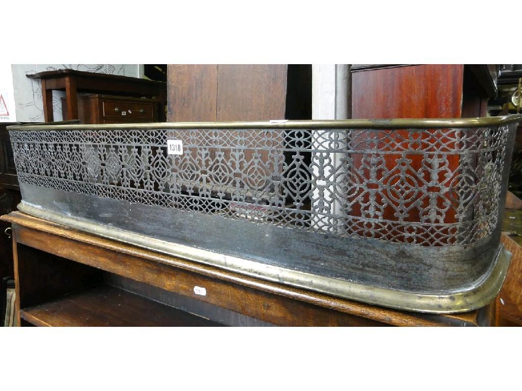 Appraisal: A th century brass and steel fender with pierced fretwork