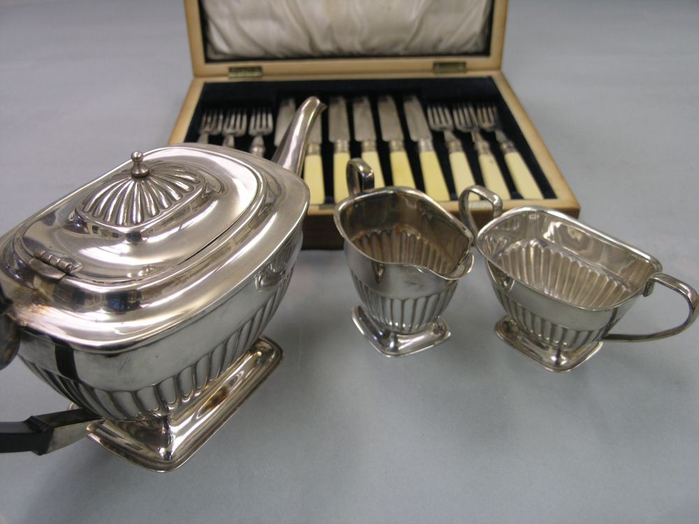 Appraisal: A silver plated three-piece teaset half-fluted pedestal form together with