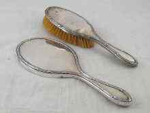 Appraisal: A hallmarked silver hand mirror and hairbrush Birmingham