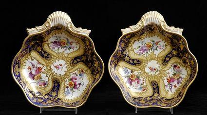 Appraisal: PAIR OF ENGLISH PORCELAIN SHELL-FORM DISHES Each with floral reserves