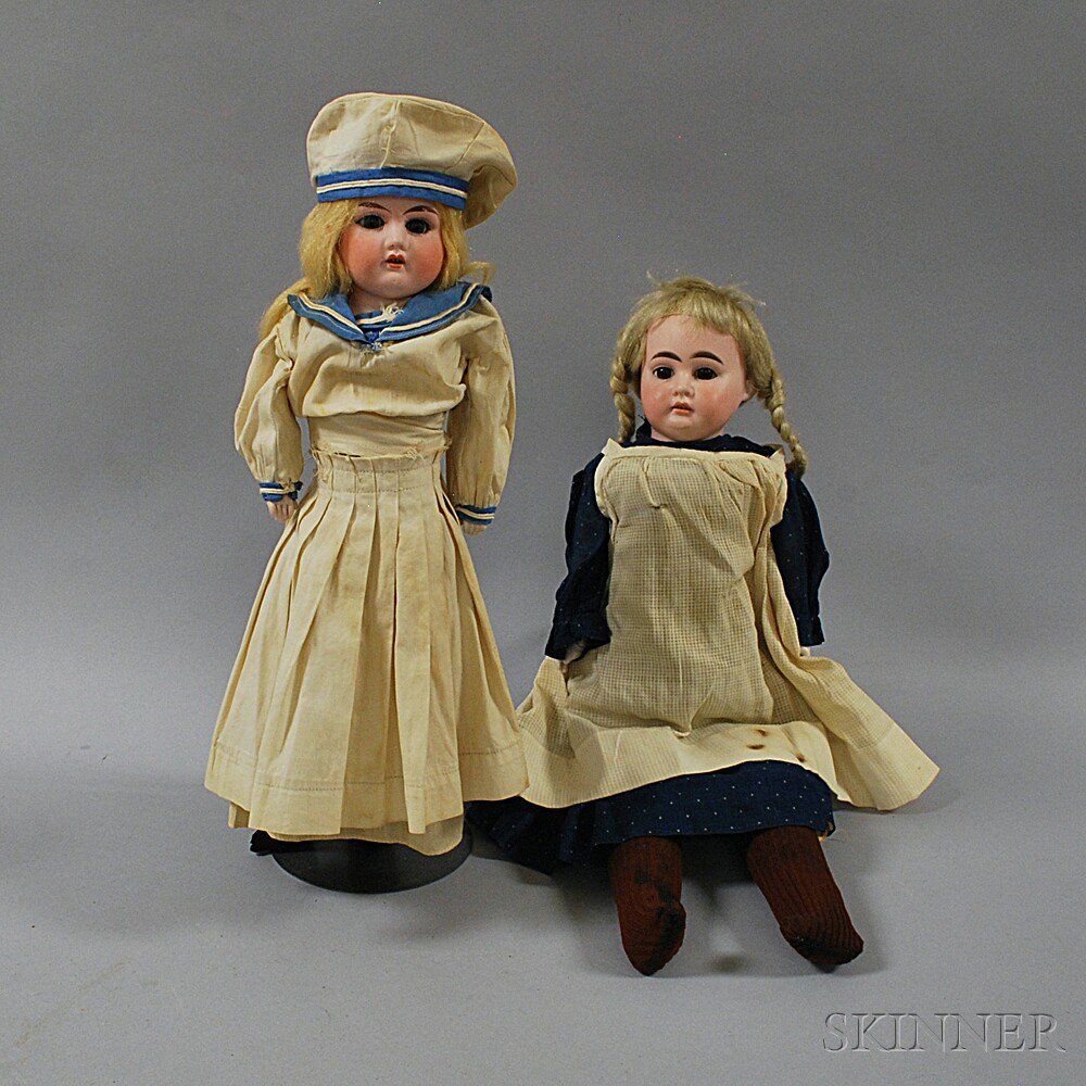 Appraisal: Two Blonde Bisque Shoulder Head Girl Dolls an Armand Marseille