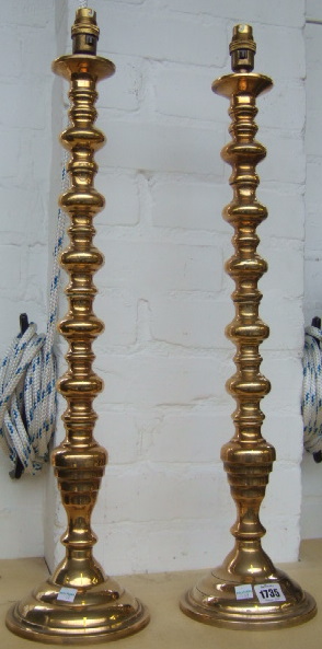 Appraisal: A pair of brass table lamps th century with bobbin