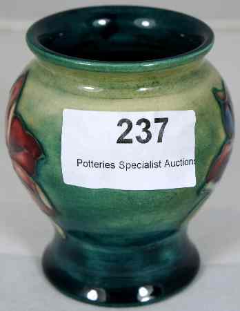 Appraisal: Moorcroft vase decorated in the hibiscus design on Green ground