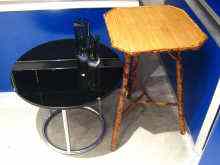 Appraisal: A round black glass and chrome tube side table and