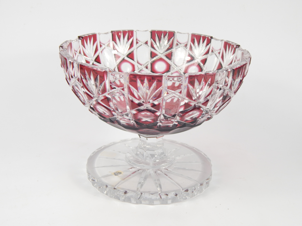 Appraisal: A Continental ruby flashed glass fruit bowl raised on an