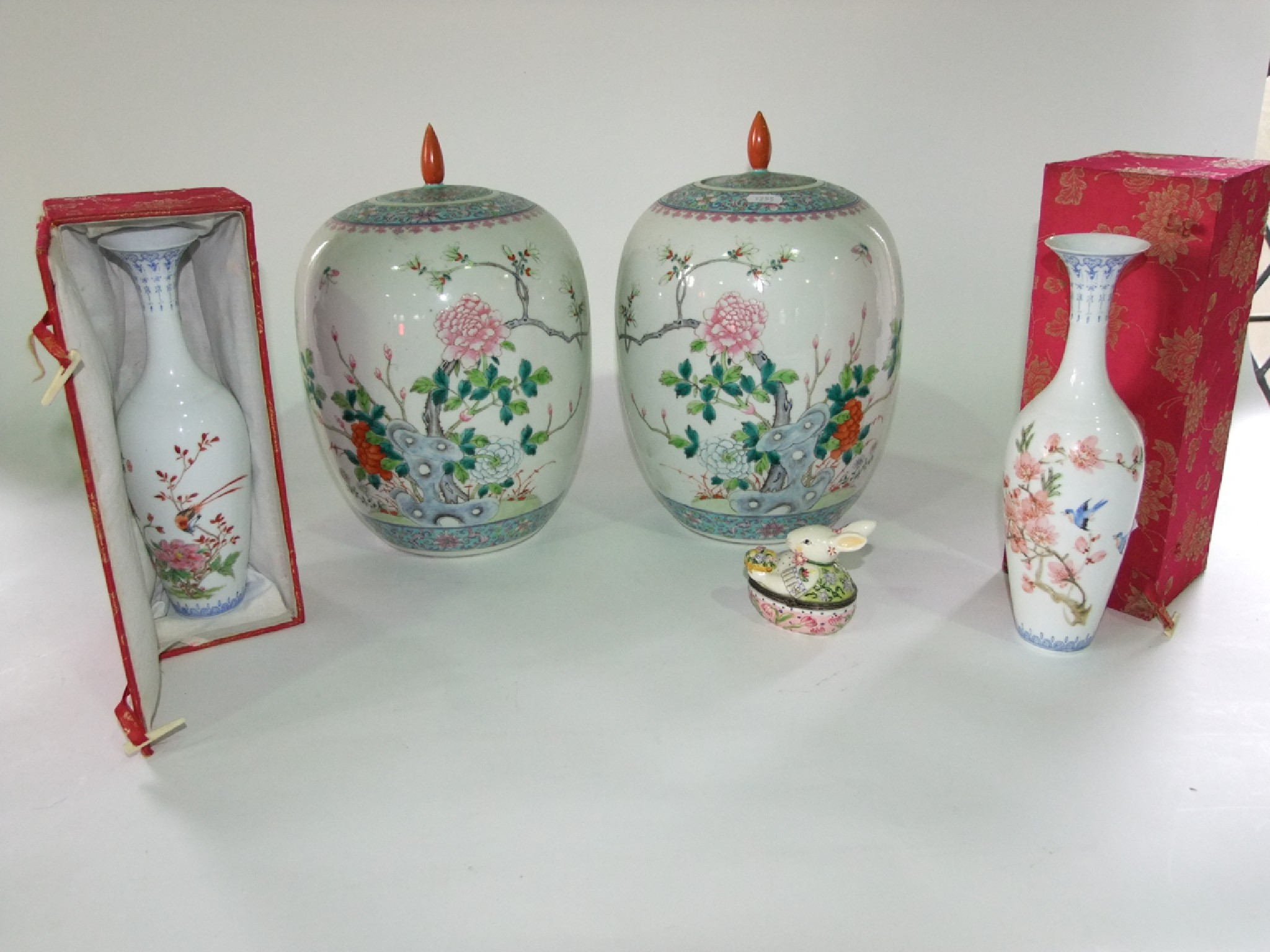 Appraisal: A pair of oriental white ground vases and covers of