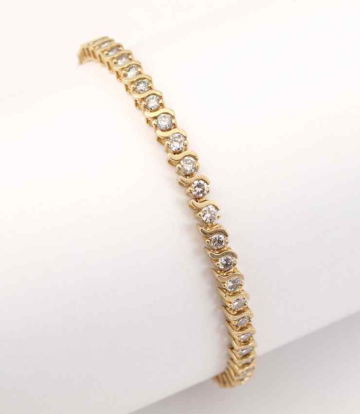 Appraisal: CT DIAMOND TENNIS BRACELET K yellow gold bracelet contains round