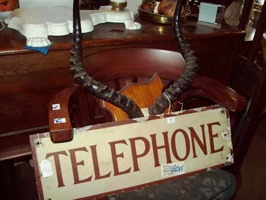 Appraisal: AN ANTIQUE ENAMEL TELEPHONE SIGN AND AN IMPALA HORN PLAQUE