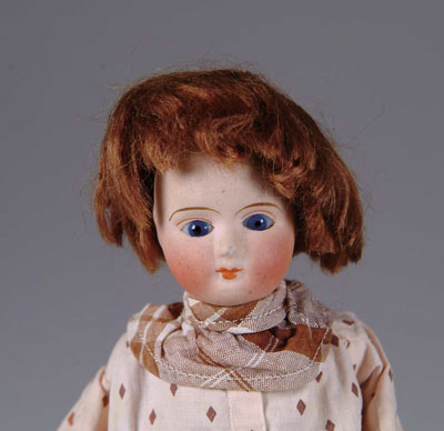 Appraisal: MECHANICAL WALKING DOLL An intriguing little bisque-headed doll with cobalt