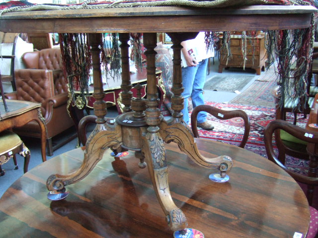 Appraisal: A Victorian walnut loo table the marquetry inlaid top raised