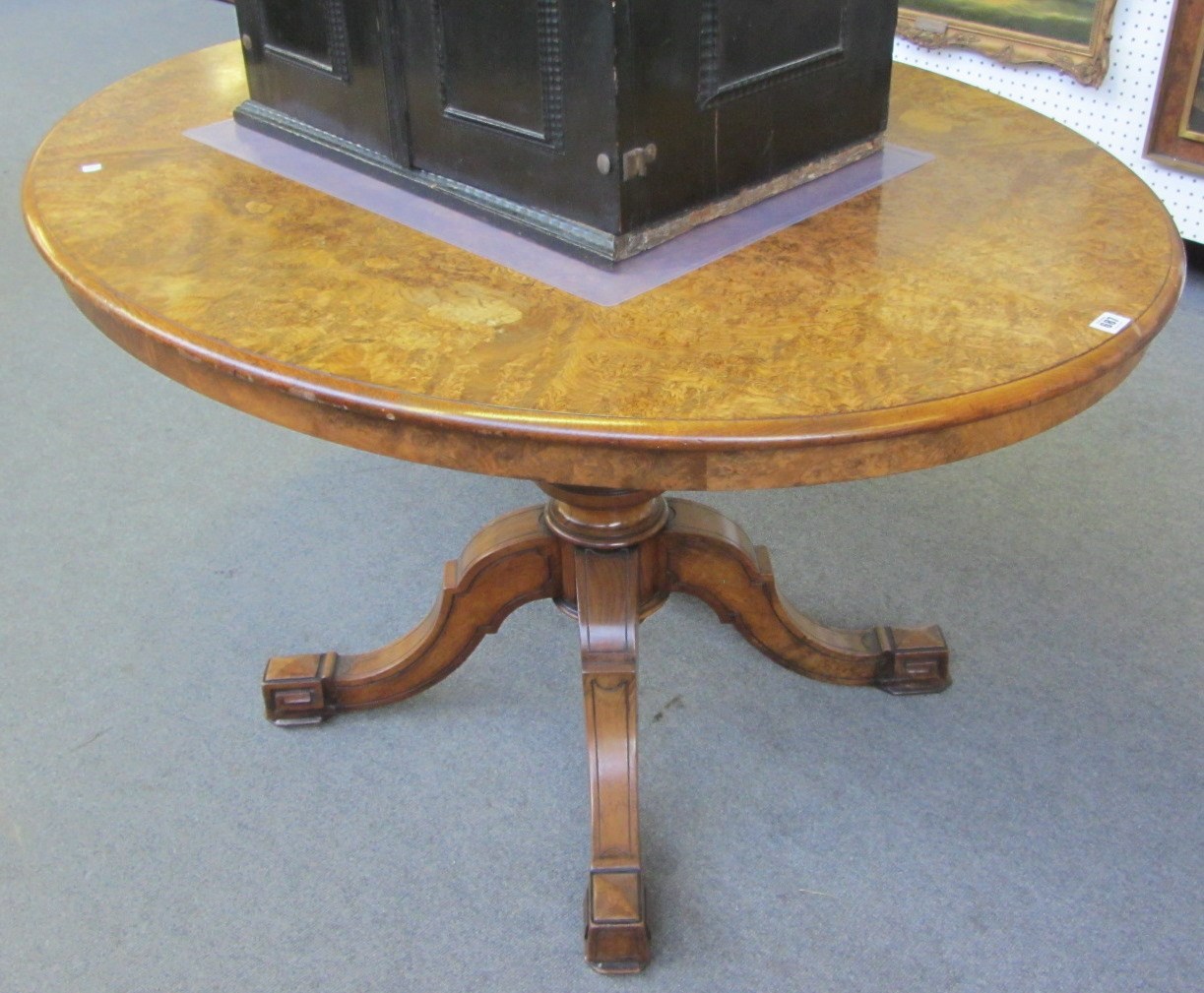 Appraisal: A Victorian figured walnut oval pivot top loo table on