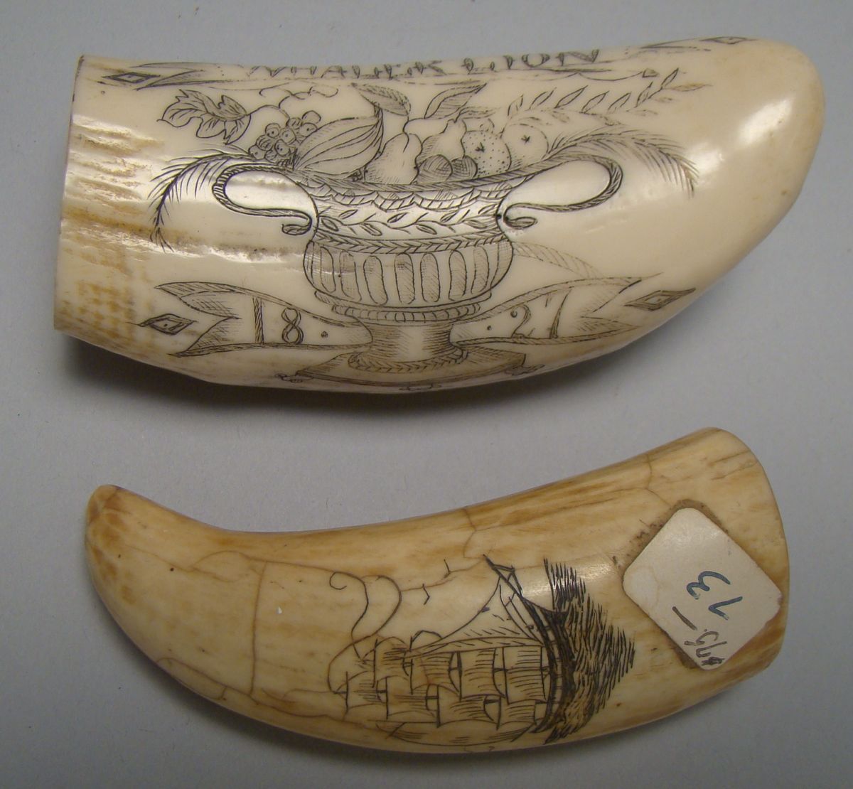 Appraisal: TWO SMALL SCRIMSHAW WHALE'S TEETH With th century decoration One