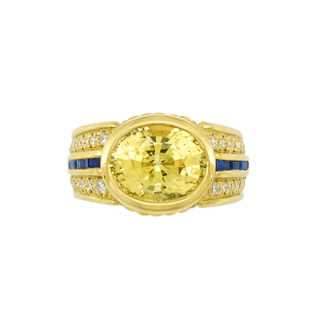 Appraisal: Gold Yellow Sapphire Sapphire and Diamond Ring One oval yellow