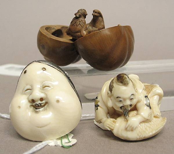 Appraisal: One boxwood and two ivory netsuke The first fashioned as