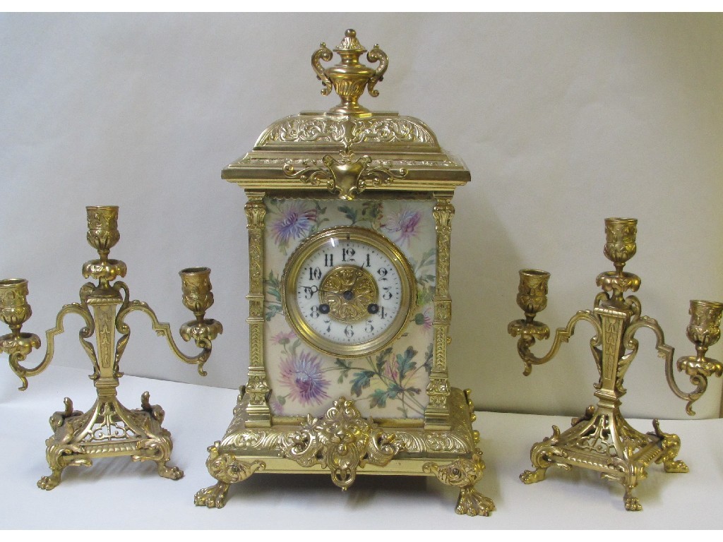 Appraisal: A French brass and porcelain mounted three piece clock garniture