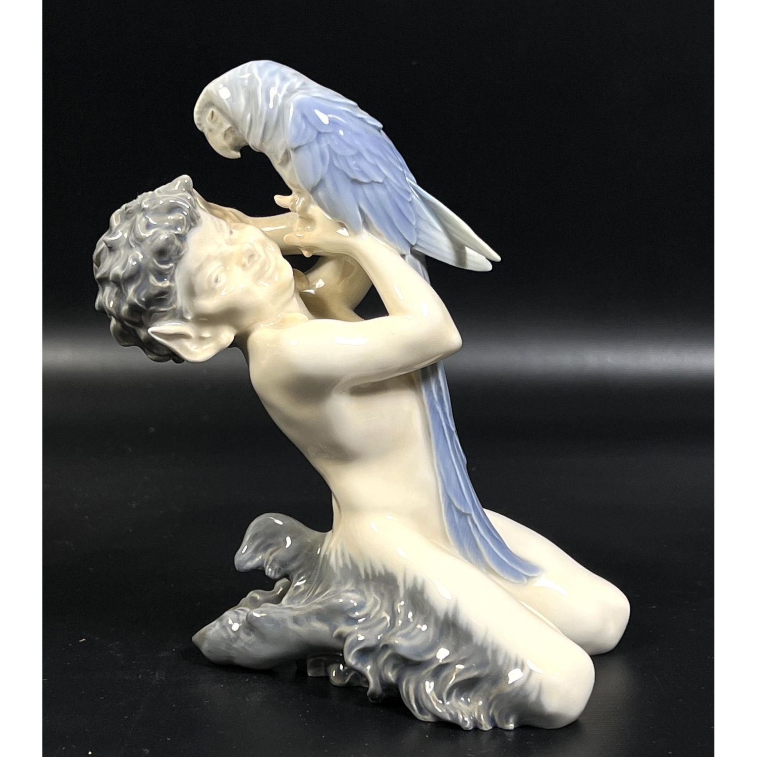 Appraisal: Royal Copenhagen Porcelain Figure of Satyr with Parrot Dimensions H