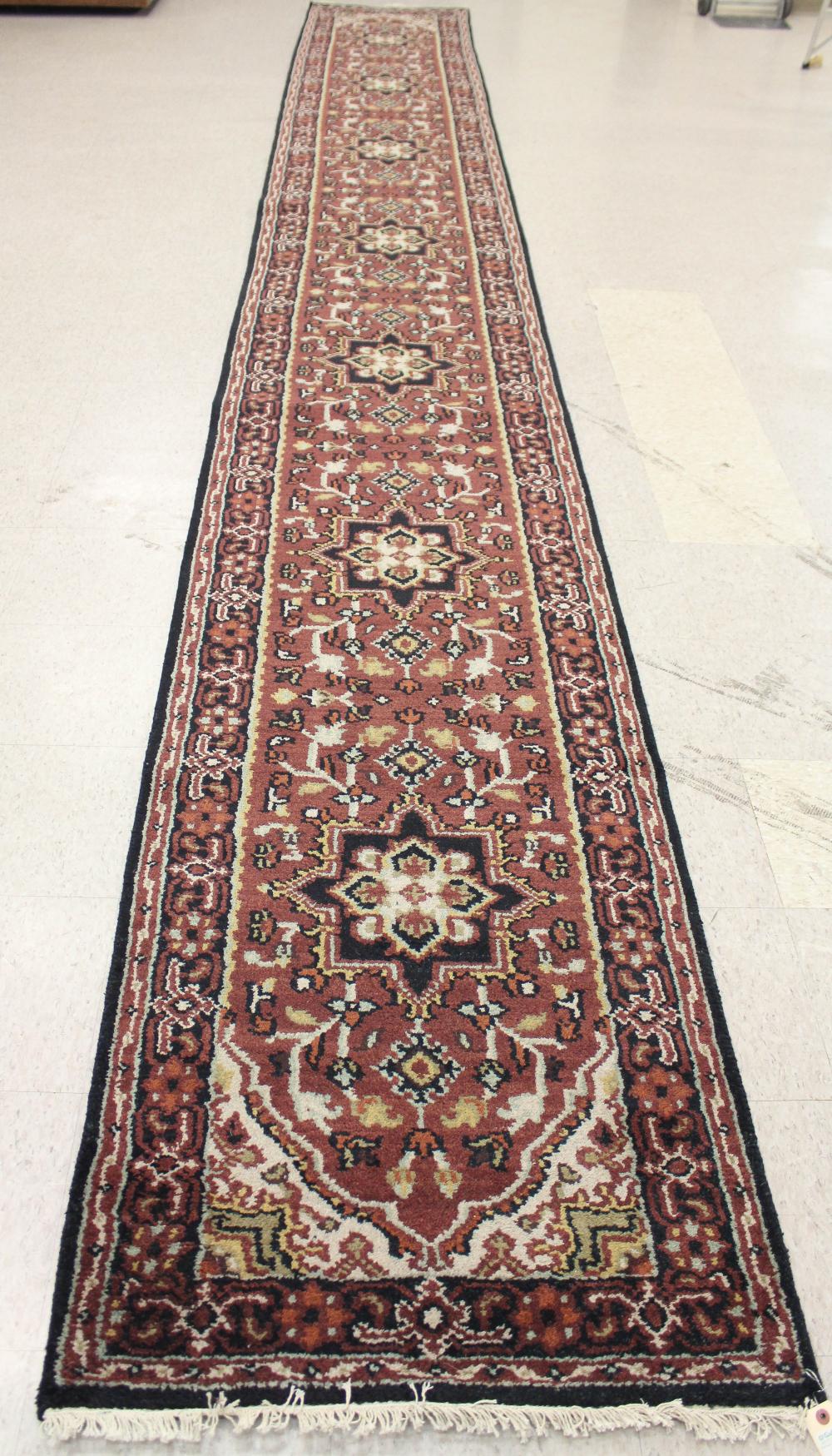 Appraisal: HAND KNOTTED ORIENTAL CORRIDOR RUG Indo-Persian floral and seven medallion