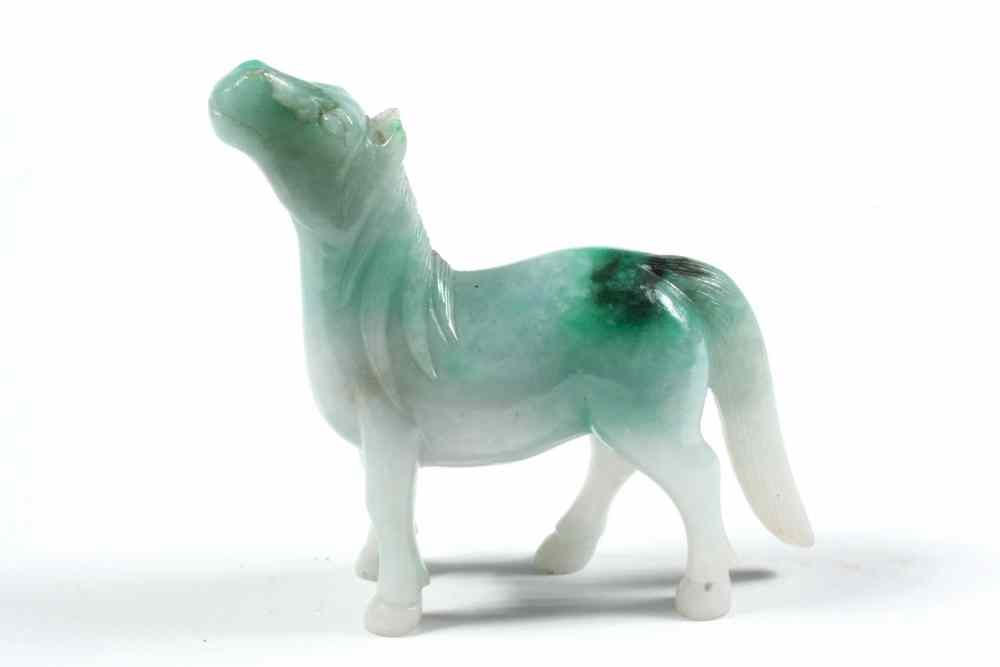 Appraisal: JADE CARVING - Early chinese Green white carved horse with