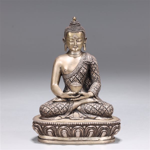 Appraisal: Nepalese silver figure of Buddha with snail curl hair and