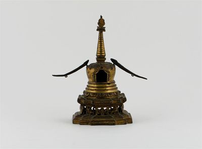 Appraisal: A Tibetan gilt bronze stupa with a fourteen stepped finial