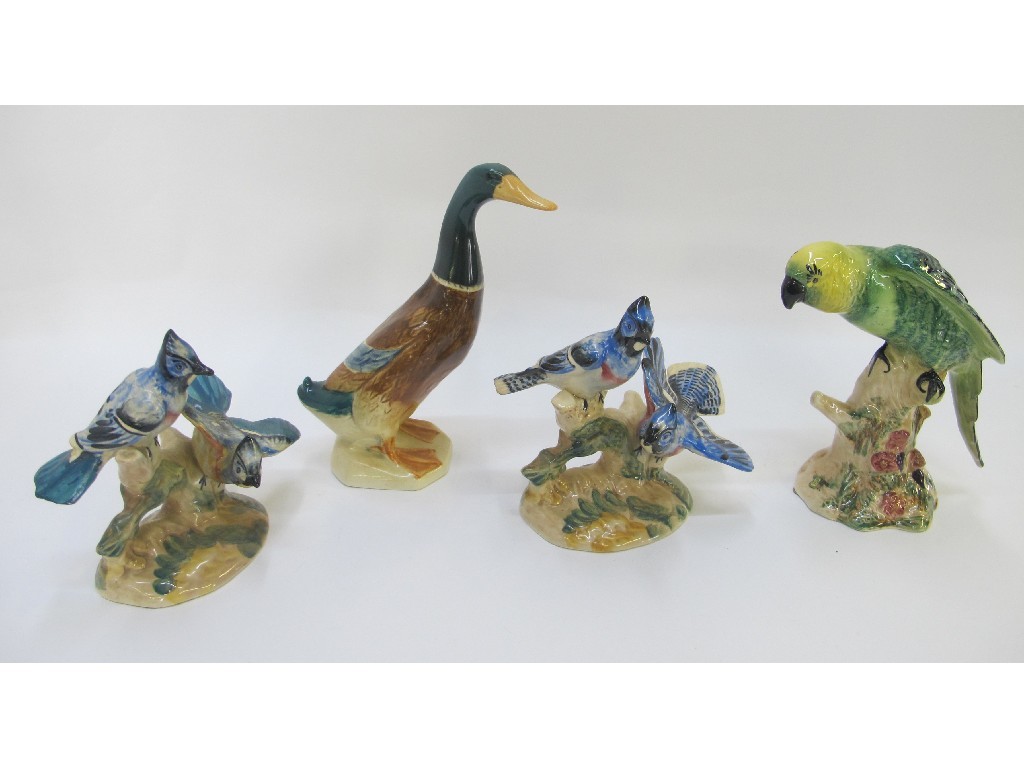 Appraisal: Four Beswick figures of birds 'Parakeet' no two blue jays