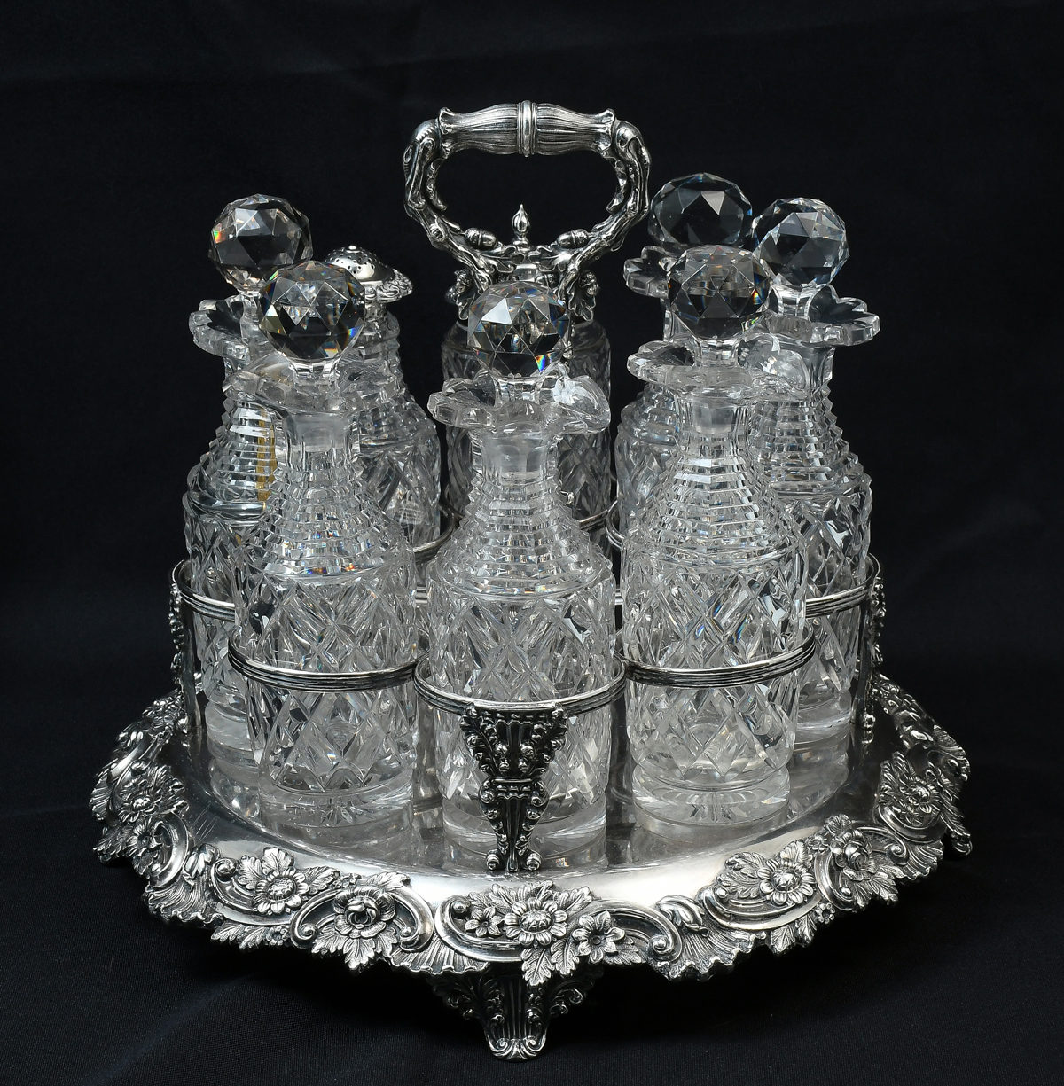 Appraisal: HIGHLY ORNATE SILVER-PLATED CRUET CONDIMENT SET Silver plated base having