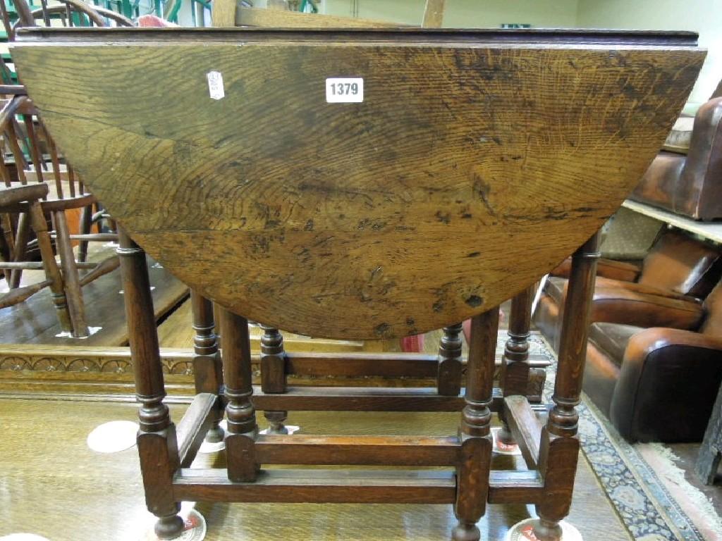 Appraisal: A small oak oval drop leaf gateleg occasional table in