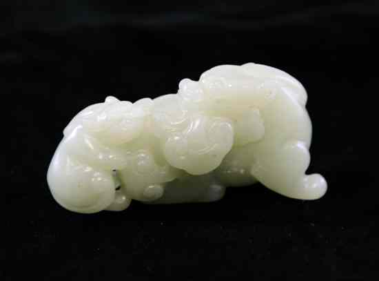 Appraisal: A Chinese pale celadon jade carving of a lion dog