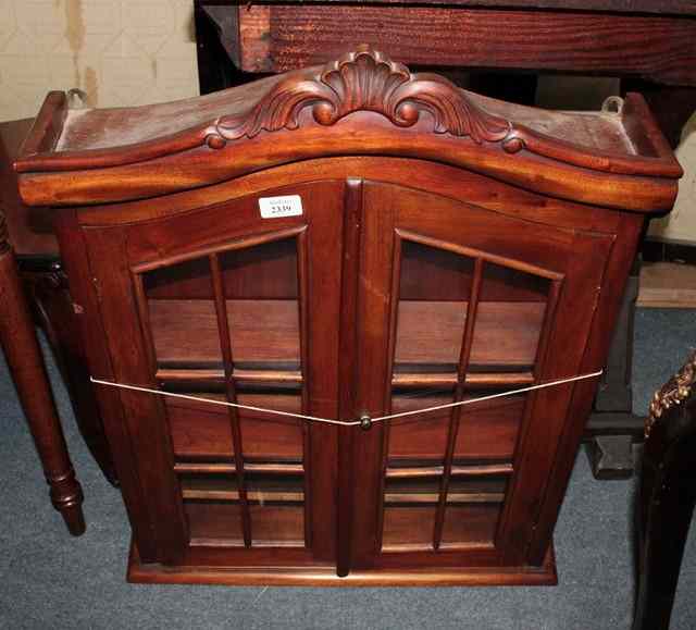 Appraisal: A MAHOGANY WALL MOUNTED DISPLAY CABINET the interior fitted two