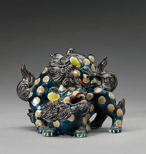 Appraisal: A Kutani enameled porcelain shishi group Meiji Taisho Period Molded