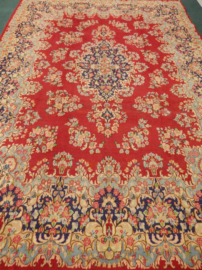 Appraisal: A Lori rug with a medallion design on a red