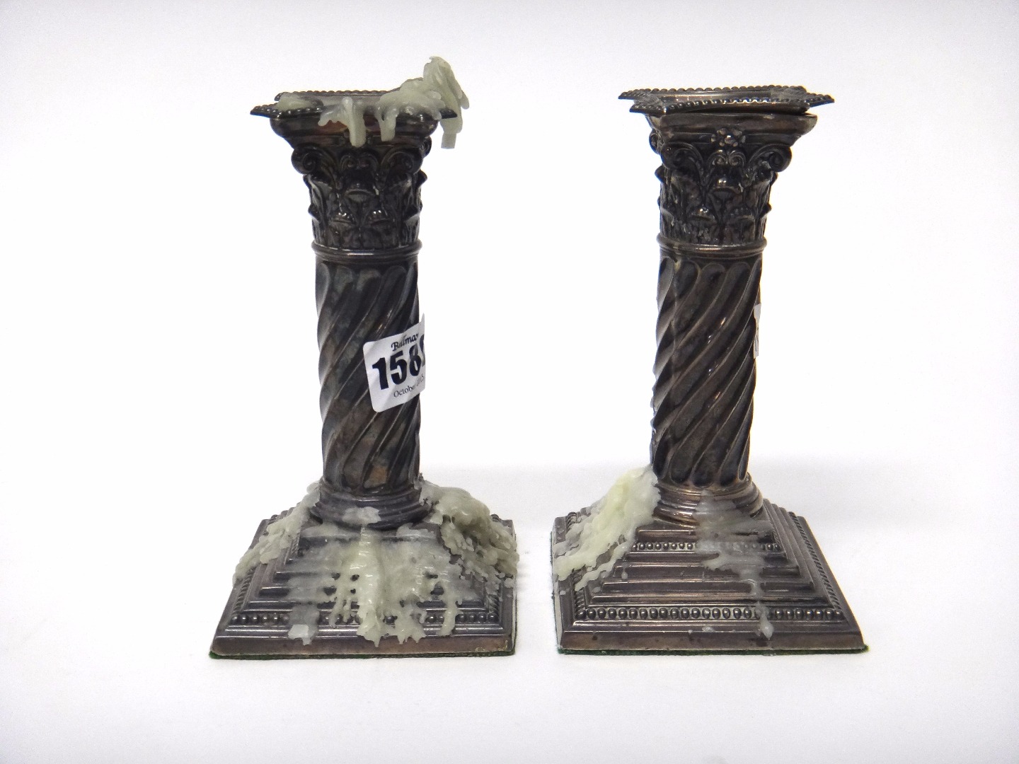 Appraisal: A pair of silver candlesticks each of Corinthian column form