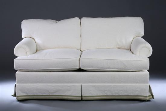 Appraisal: TRADITIONAL BOX-FORM LOVE SEAT Late th century Rist Corporation cream