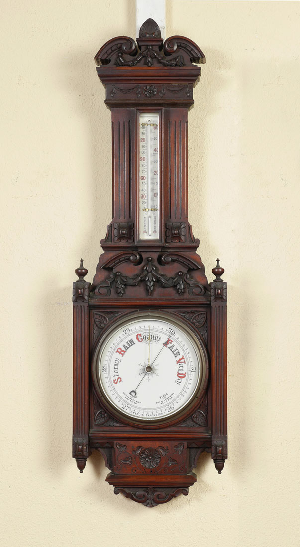 Appraisal: VICTORIAN CARVED WALNUT ANEROID BAROMETER Carved walnut case with applied