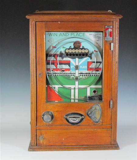 Appraisal: A 'Win and Place' slot machine contained in an oak