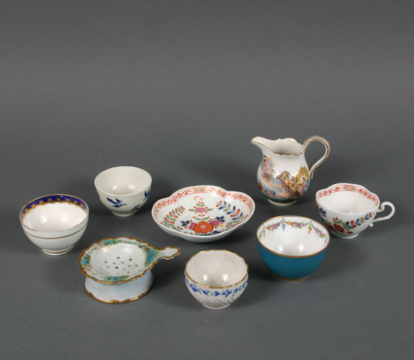 Appraisal: Eight hand painted porcelain objects creamer cups saucer and strainer