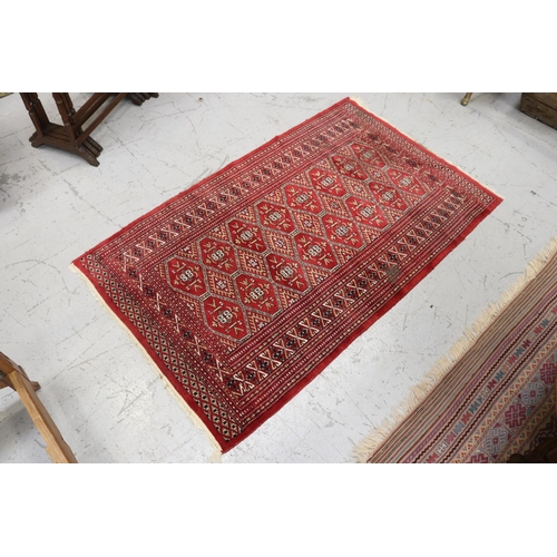 Appraisal: Handwoven wool carpet with red ground approx cm x cm