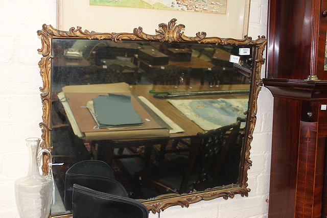 Appraisal: A GILT FRAMED RECTANGULAR WALL MIRROR with decorative scrolling frame