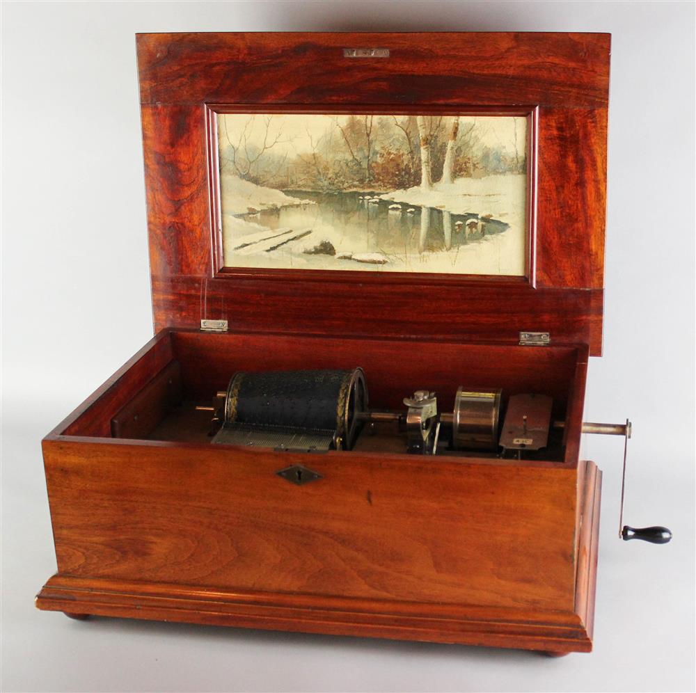 Appraisal: CAPITAL CASED MUSIC BOX in wooden case with paneled lid