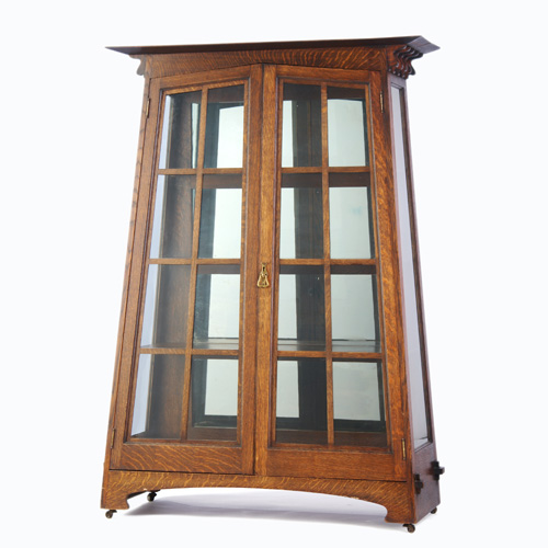 Appraisal: ARTS CRAFTS Trapezoidal china cabinet with overhanging top supported by