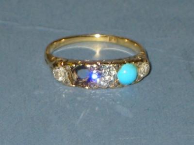 Appraisal: A TURQUOISE AND DIAMOND RING having three brilliant cut diamonds