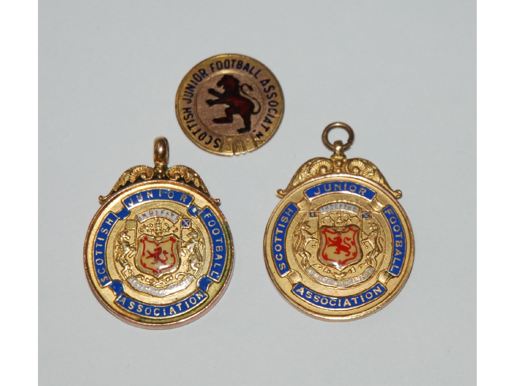 Appraisal: Two ct gold and enamel Scottish Junior football medals -