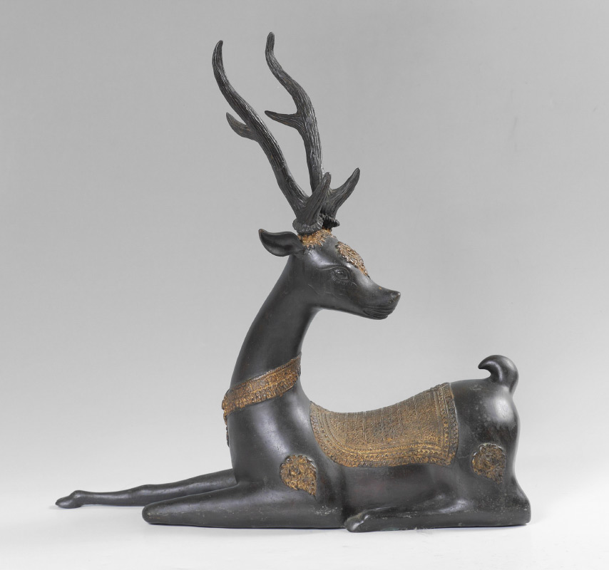 Appraisal: SOUTHEAST ASIAN PATINATED METAL FIGURE OF RECUMBENT DEER With gold