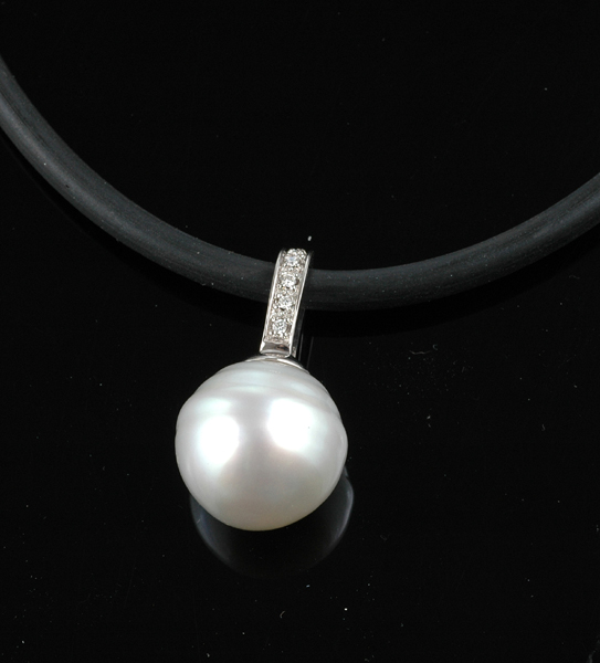 Appraisal: A South Sea pearl and diamond enhancer-pendant The round silver-white