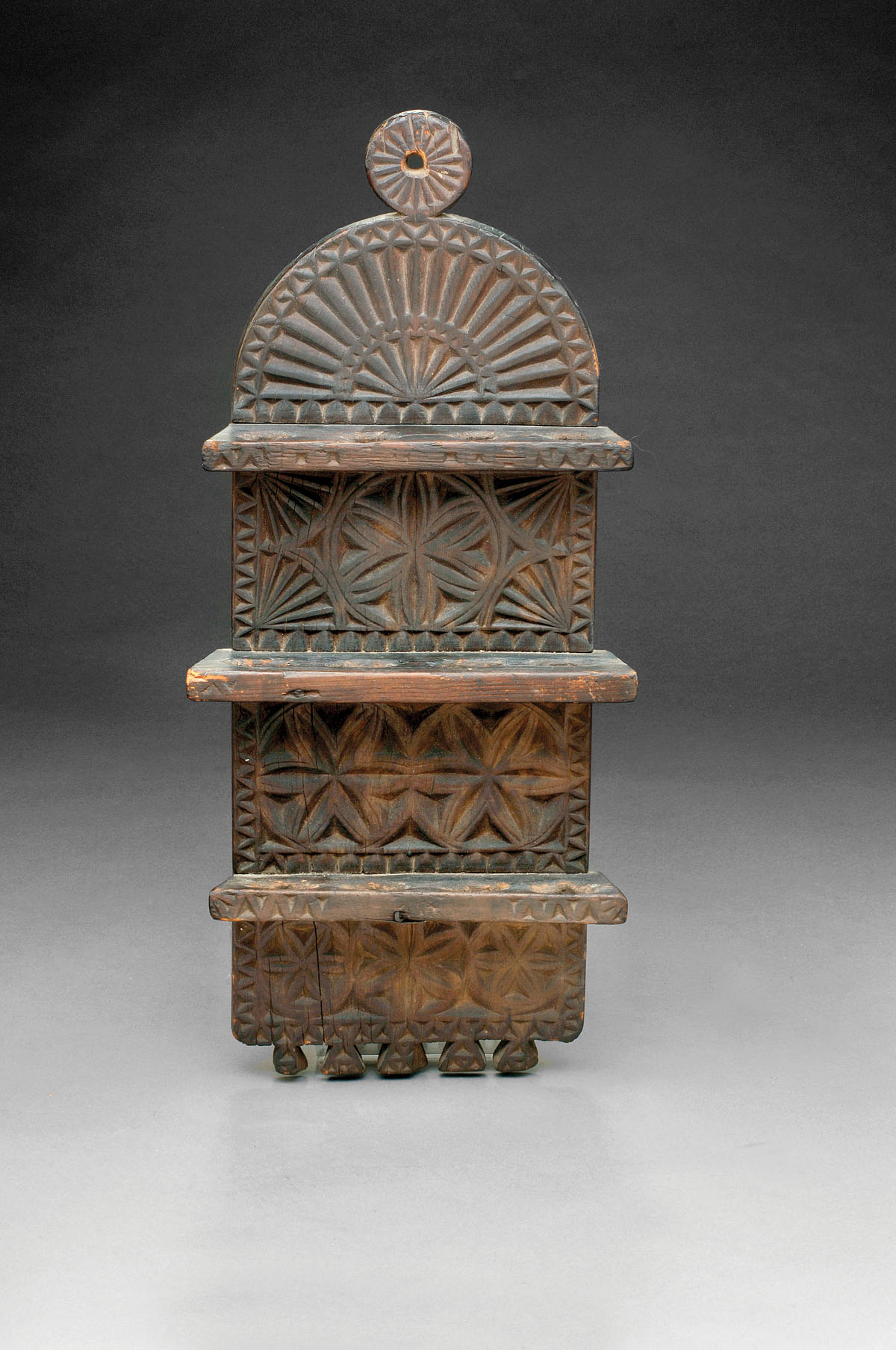 Appraisal: ELABORATELY CARVED SPOON RACK WITH PINWHEEL AND FAN DECORATION Height