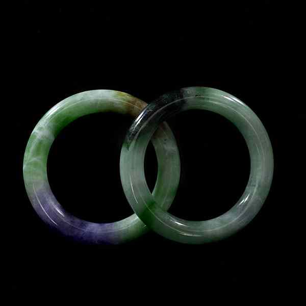 Appraisal: Chinese Jade Bangles Chinese Two apple green jade bracelets one