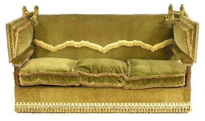 Appraisal: A three seater knole settee upholstered green fringed velvet with