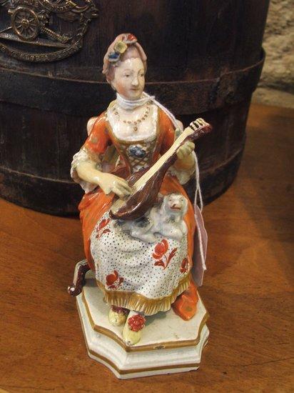 Appraisal: A TH CENTURY PORCELAIN FIGURE of a seated lady playing