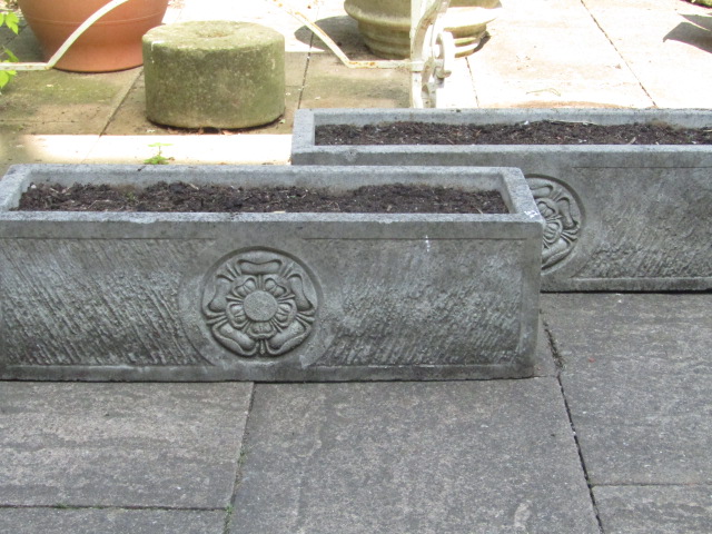 Appraisal: A pair of modern rectangular stone planters with rose boss