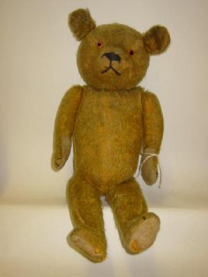 Appraisal: A pre-war English teddy bear straw filled covered in gold